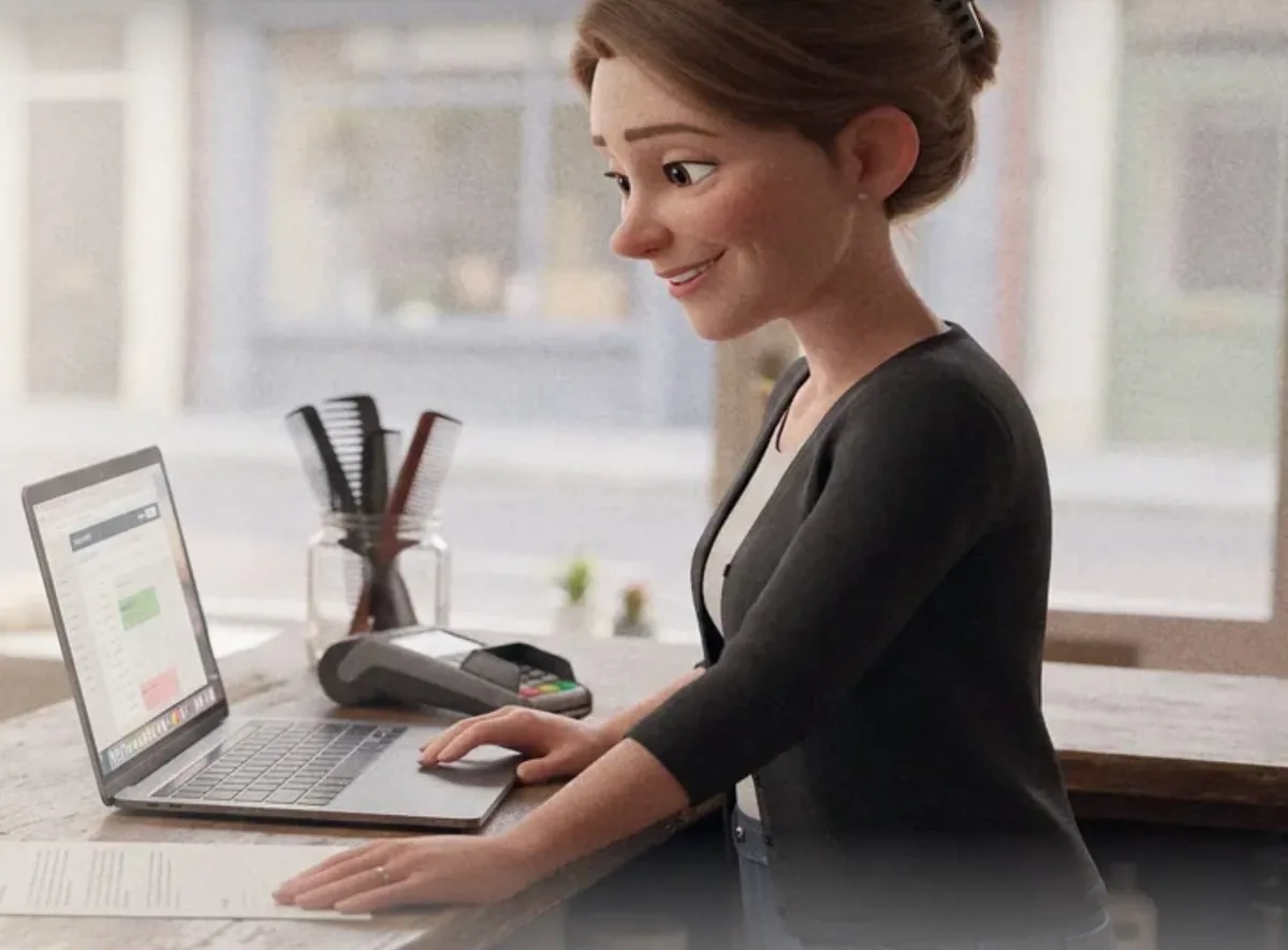 A salon owner checking her inbox on a laptop